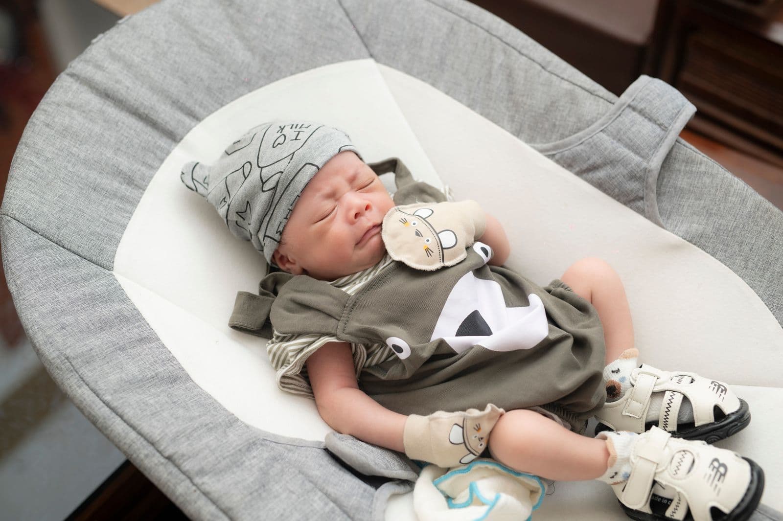 A newborn asleep in a white bassinet